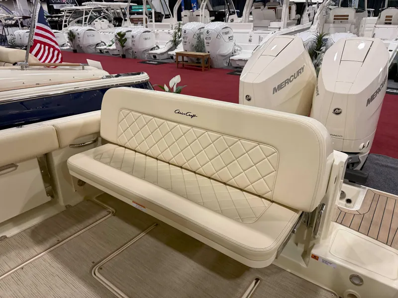 Slide: The Image of 2025 Chris-Craft Catalina 30 boat displayed in a showroom with other vessels. - 2