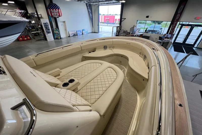 Slide: The Image of Luxurious interior of 2025 Chris-Craft Catalina 30 boat with beige seating and wood accents. - 21