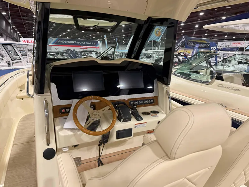 Slide: The Image of 2025 Chris-Craft Catalina 30 boat displayed indoors, featuring sleek design and luxurious seating. - 4