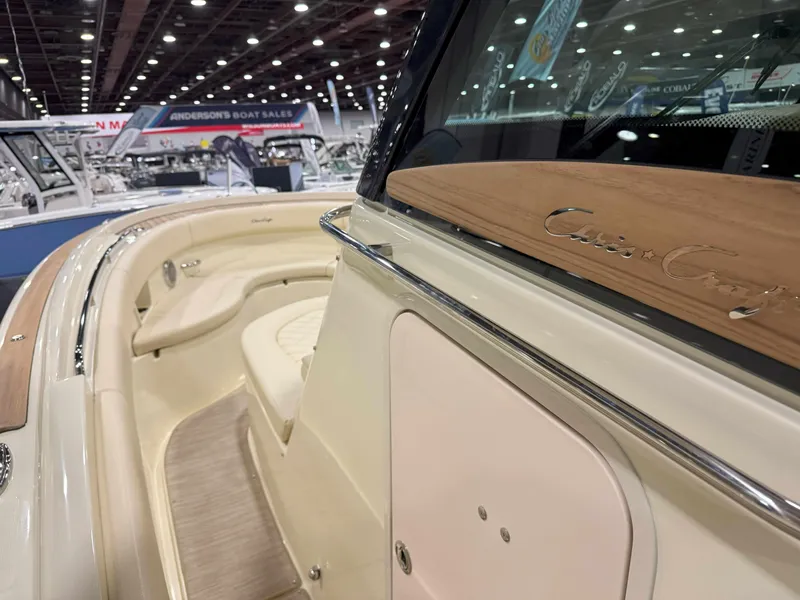 Slide: The Image of 2025 Chris-Craft Catalina 30 boat at a showroom, featuring dual Mercury engines and luxury seating. - 7