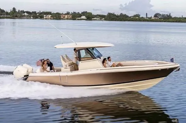 Slide: The Image of 2025 Chris-Craft Catalina 30 interior with luxurious seating and modern dashboard at a boat show. - 9