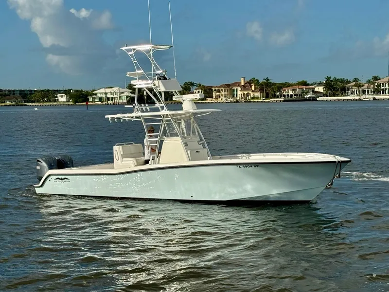The Image of 2020 Invincible 33 Open Fisherman boat on calm water, coastal background. - 0