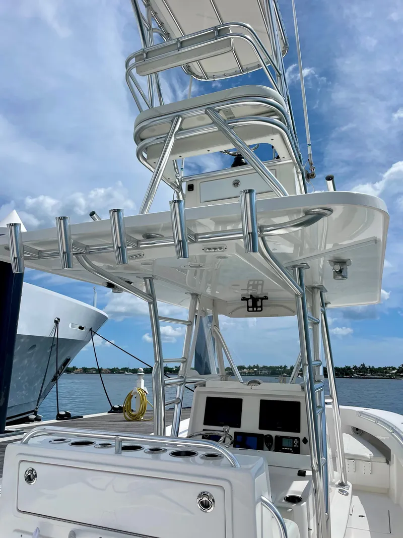 Slide: The Image of 2020 Invincible 33 Open Fisherman boat with tower against blue sky. - 15