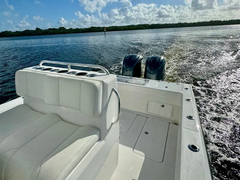 Slide: The Image of 2020 Invincible 33 Open Fisherman boat on water, featuring dual engines and white seating. - 18