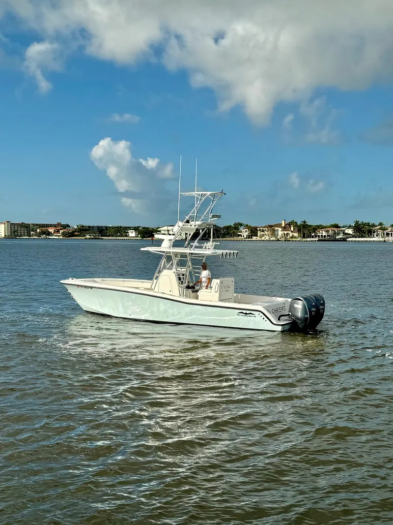 Slide: The Image of 2020 Invincible 33 Open Fisherman boat on calm waters under a blue sky. - 32
