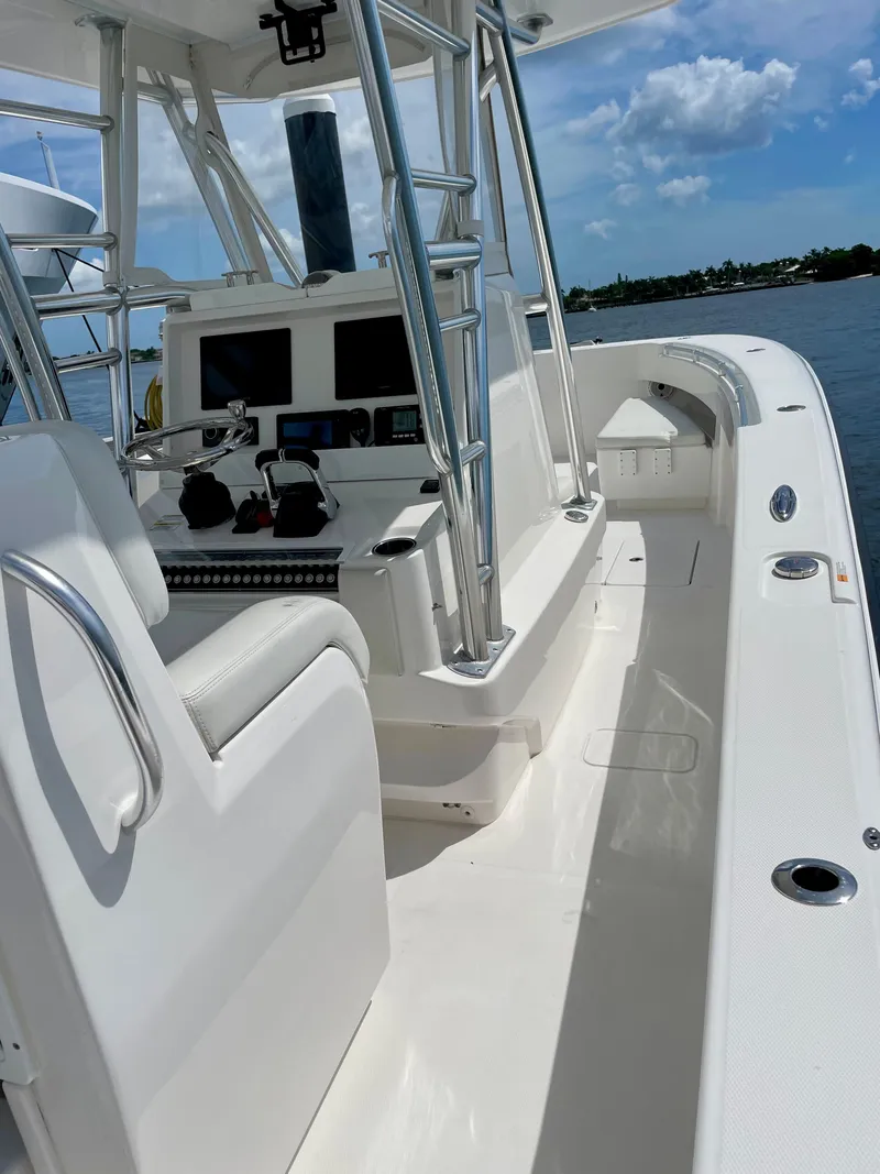 Slide: The Image of 2020 Invincible 33 Open Fisherman boat, sleek design, spacious deck, and modern controls. - 6