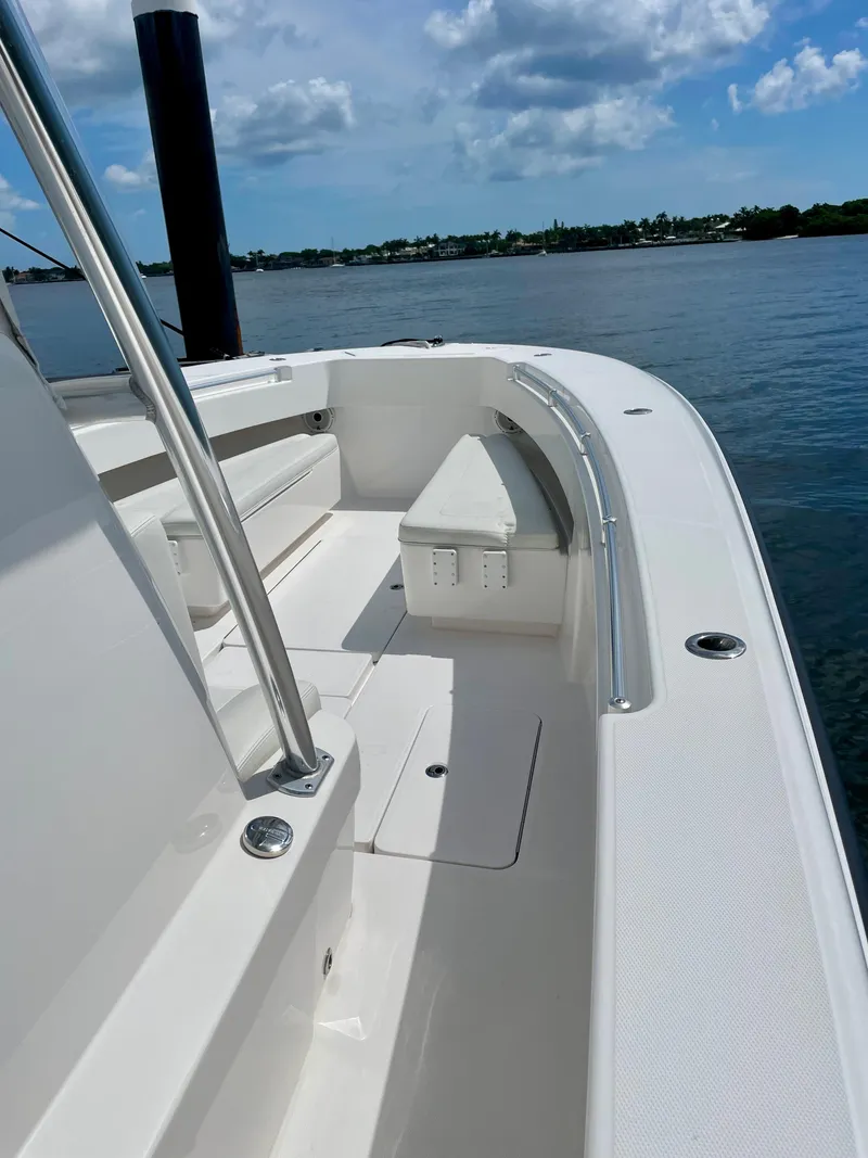 Slide: The Image of 2020 Invincible 33 Open Fisherman boat on calm water under blue sky. - 7