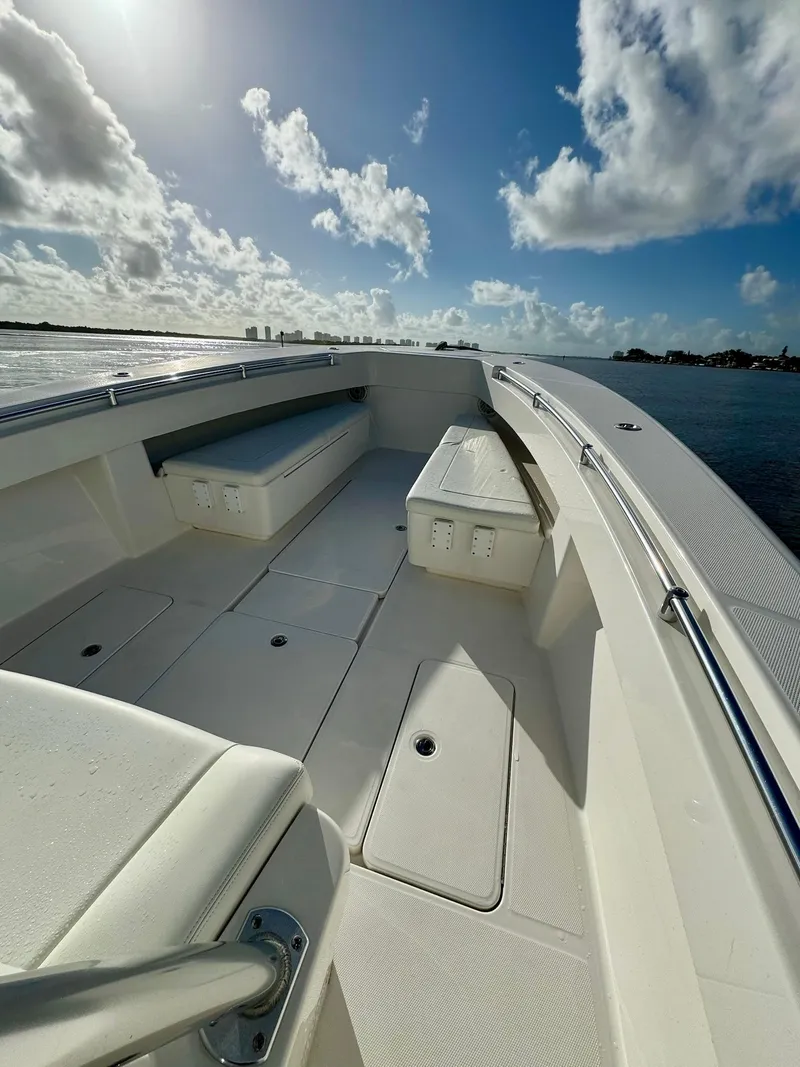 Slide: The Image of 2020 Invincible 33 Open Fisherman boat deck under a bright blue sky. - 9