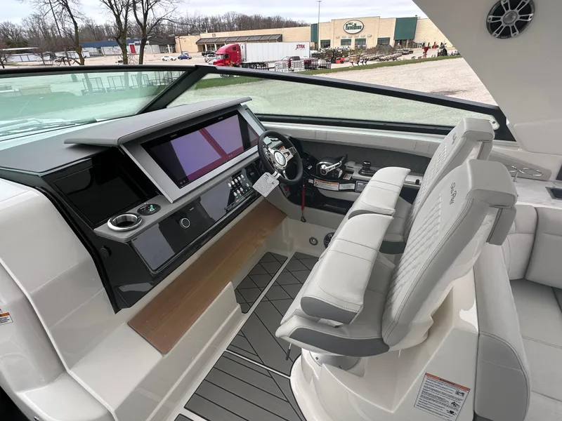 Slide: The Image of 2025 Sea Ray SLX 400 OB helm with modern controls and dual seating. - 10