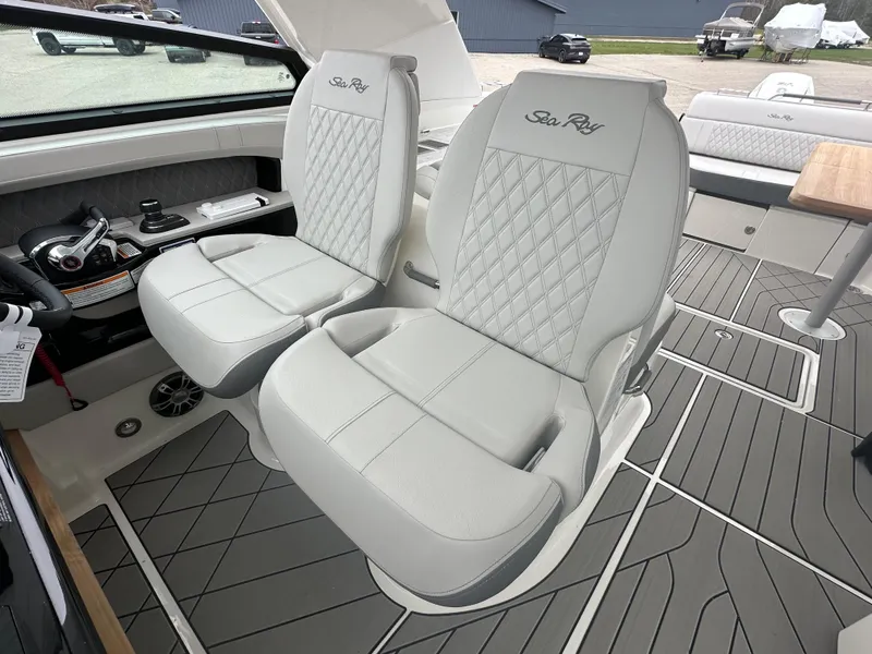 Slide: The Image of 2025 Sea Ray SLX 400 OB boat interior with luxurious seating and modern design. - 11