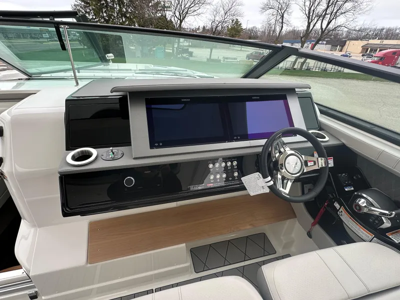 Slide: The Image of 2025 Sea Ray SLX 400 OB helm with modern controls and dual screens. - 12