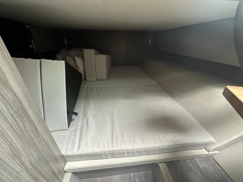 Slide: The Image of 2025 Sea Ray SLX 400 OB cabin interior with cushioned seating and modern design. - 22