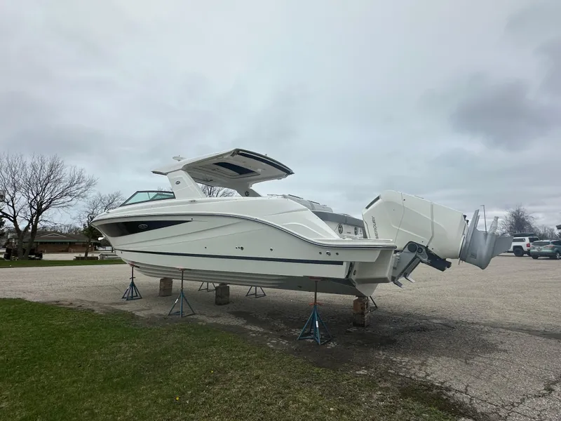 Slide: The Image of 2025 Sea Ray SLX 400 OB boat on stands in a parking lot. - 3