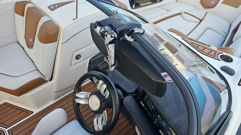 Slide: The Image of 2018 Nautique Super Air Nautique G25 interior with damaged dashboard and steering wheel. - 10