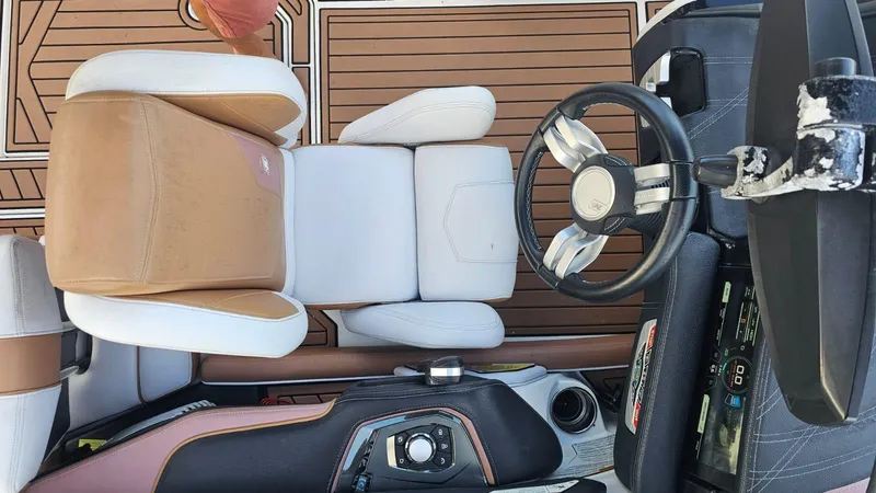 Slide: The Image of 2018 Nautique Super Air Nautique G25 cockpit with steering wheel and seating. - 11