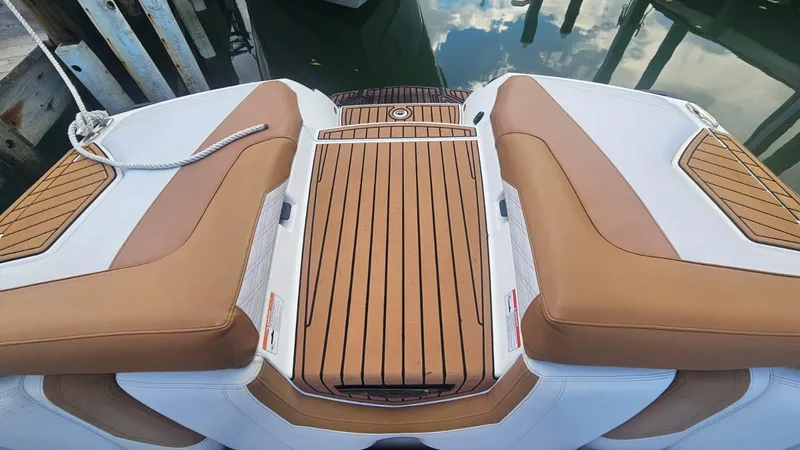 Slide: The Image of 2018 Nautique Super Air Nautique G25 boat deck with brown and white seating. - 14