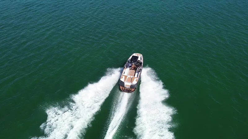 Slide: The Image of 2018 Nautique Super Air Nautique G25 cruising on open water, aerial view. - 31