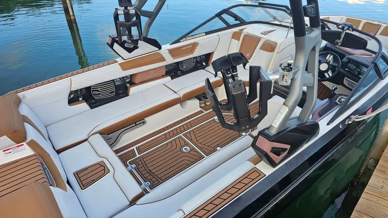 Slide: The Image of 2018 Nautique Super Air Nautique G25 interior with luxurious seating and advanced controls. - 6