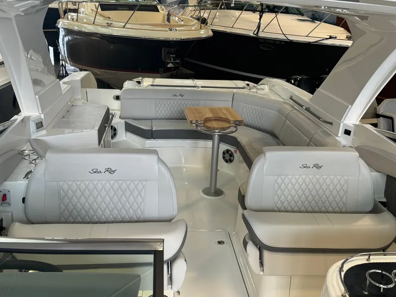 Slide: The Image of 2025 Sea Ray SLX 350 boat interior with luxurious seating and table. - 10