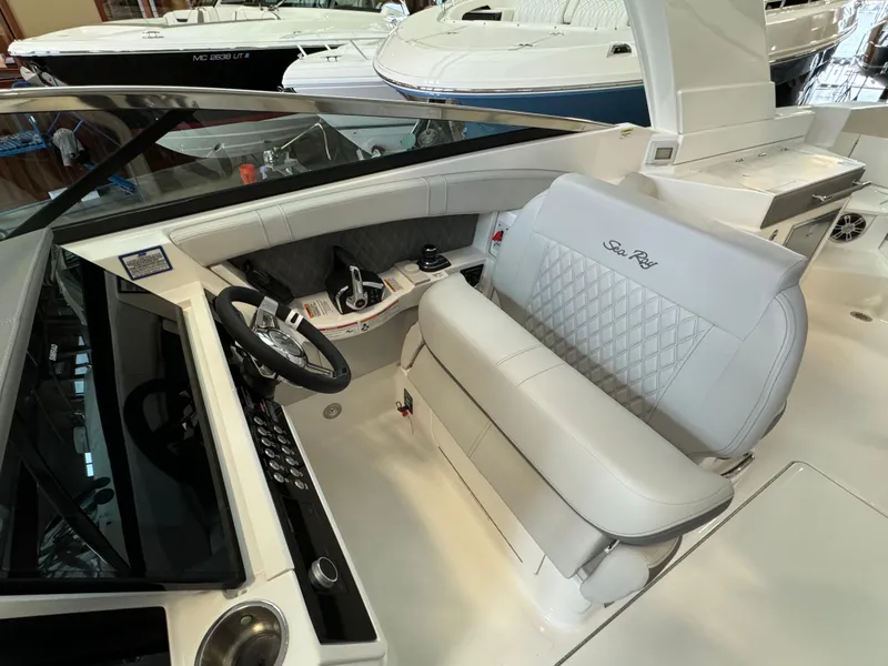 Slide: The Image of 2025 Sea Ray SLX 350 boat interior with luxurious seating and modern dashboard. - 13