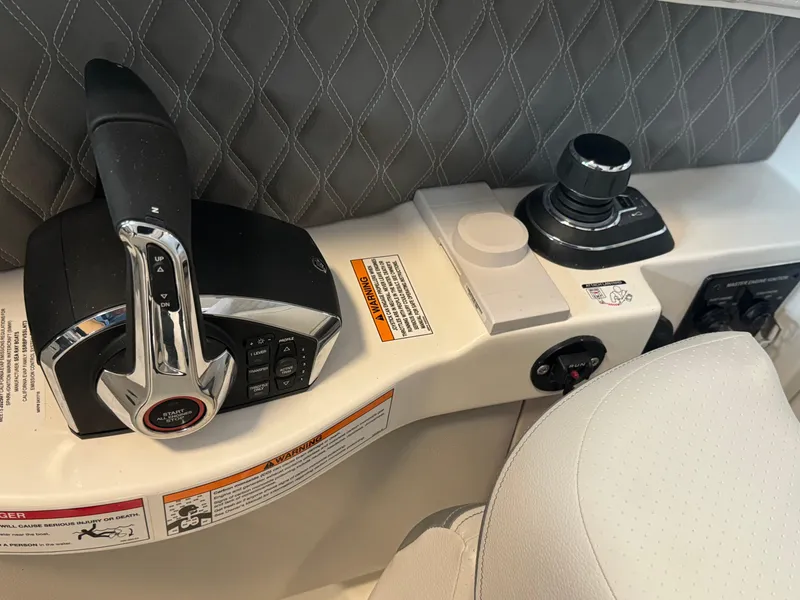 Slide: The Image of 2025 Sea Ray SLX 350 control panel with joystick and throttle. - 14