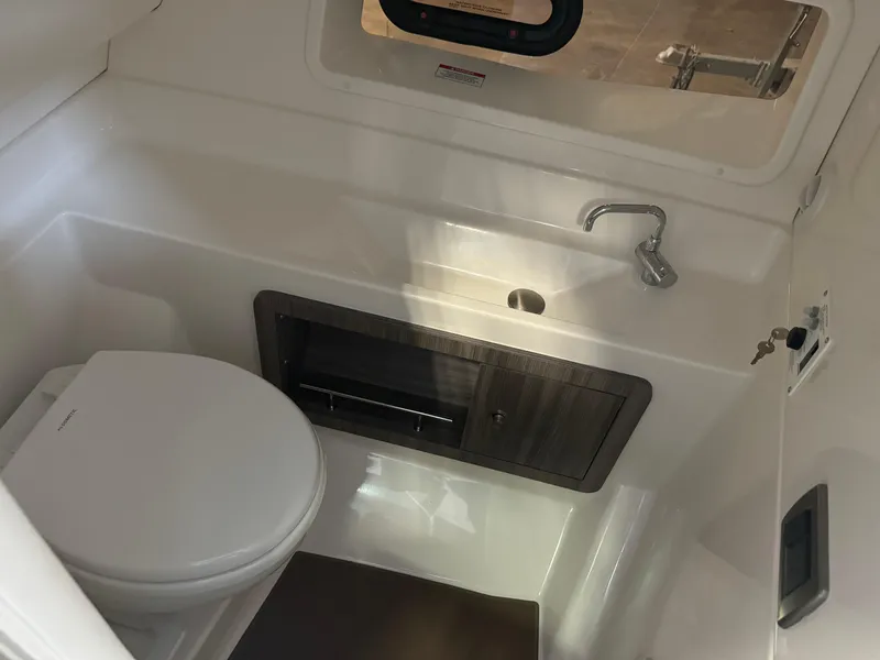 Slide: The Image of 2025 Sea Ray SLX 350 boat bathroom with sink and toilet. - 19