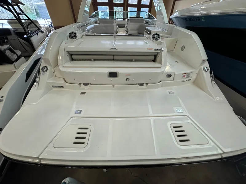Slide: The Image of 2025 Sea Ray SLX 350 boat with spacious deck and seating area. - 2