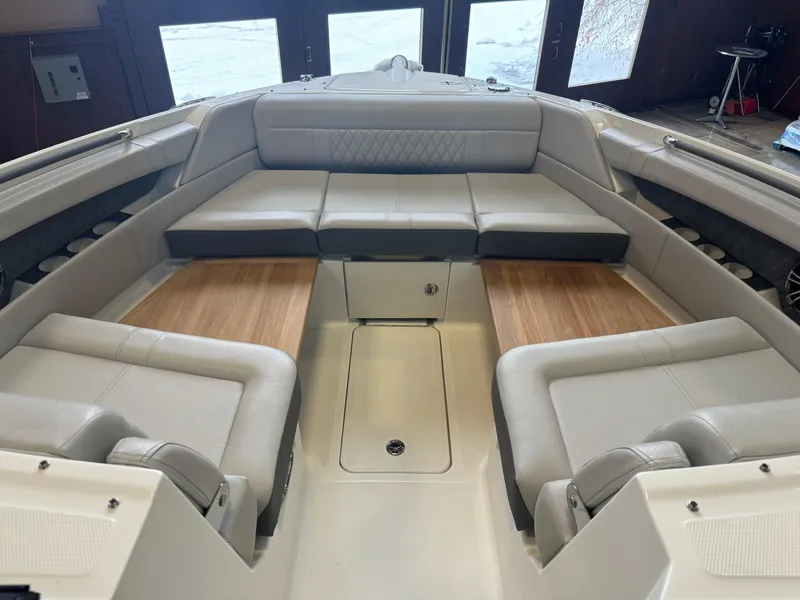 Slide: The Image of 2025 Sea Ray SLX 350 boat interior with luxurious seating and wood accents. - 20