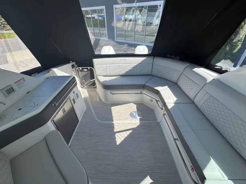 Slide: The Image of 2025 Sea Ray Sundancer 320 Coupe interior with sleek seating and modern amenities. - 13