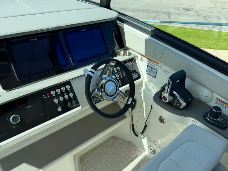 Slide: The Image of Helm of 2025 Sea Ray Sundancer 320 Coupe with modern controls and displays. - 20