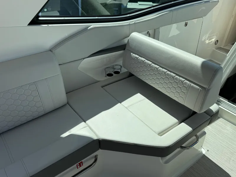 Slide: The Image of 2025 Sea Ray Sundancer 320 Coupe interior seating with modern design and luxurious upholstery. - 22