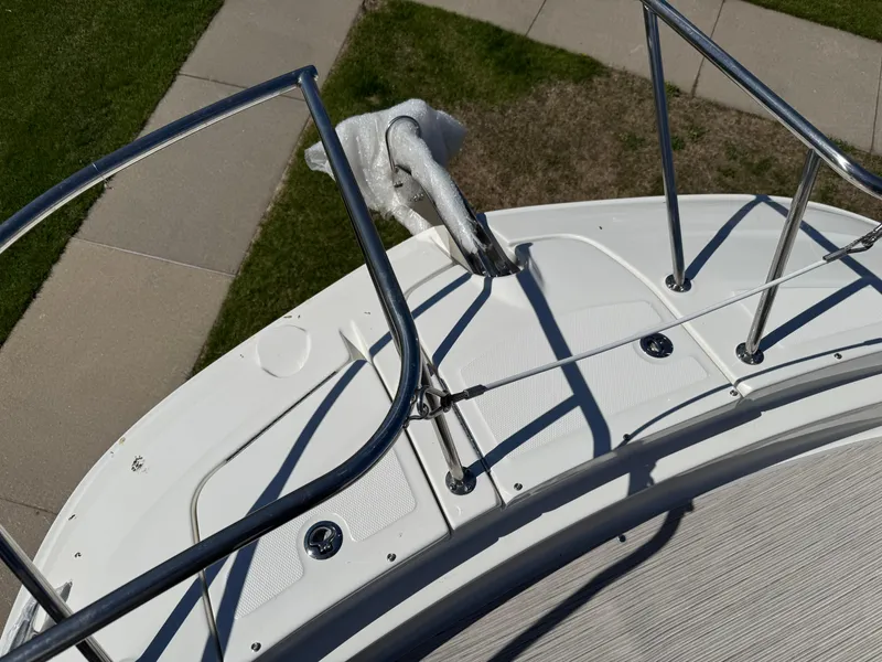 Slide: The Image of 2025 Sea Ray Sundancer 320 Coupe bow with stainless steel railings and anchor. - 6