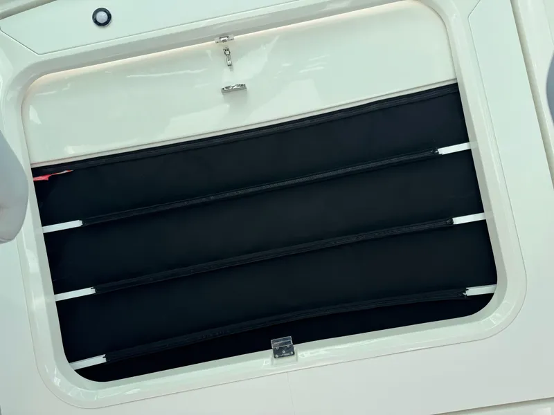 Slide: The Image of 2025 Sea Ray Sundancer 320 Coupe window detail with black slats. - 7