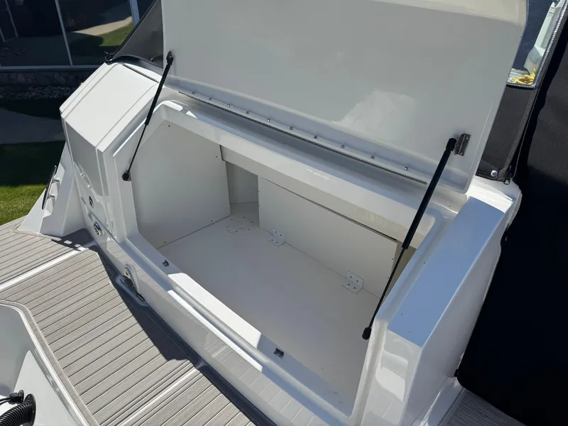 Slide: The Image of Open storage compartment on 2025 Sea Ray Sundancer 320 Coupe boat. - 9