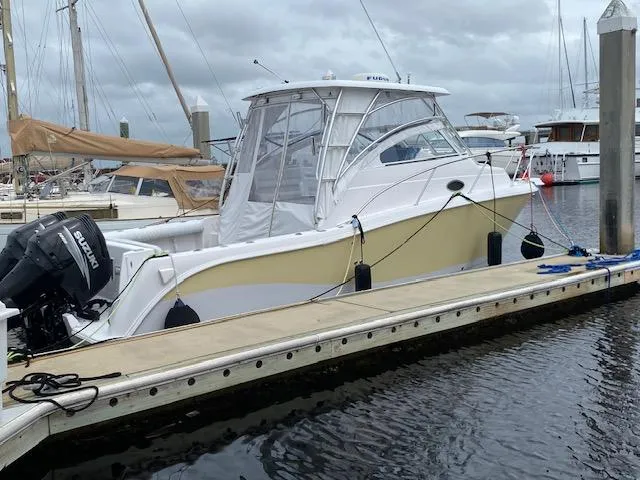 Slide: The Image of 2005 Pro-Line Express boat docked at marina with Suzuki outboard motor. - 0