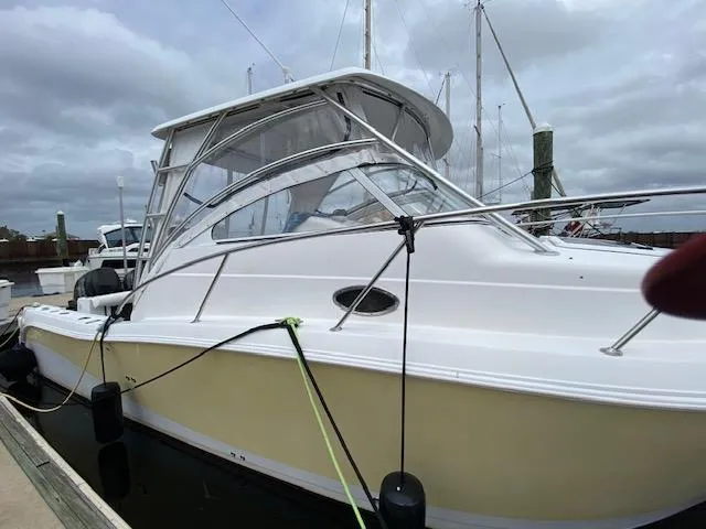 Slide: The Image of 2005 Pro-Line Express boat docked, featuring a sleek white and yellow design. - 1