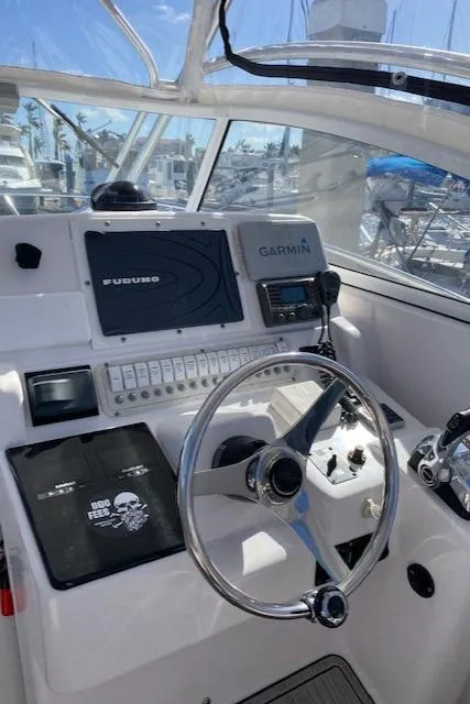 Slide: The Image of 2005 Pro-Line Express boat cockpit with navigation equipment and steering wheel. - 13