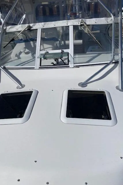 Slide: The Image of 2005 Pro-Line Express boat deck with windows and railing. - 16