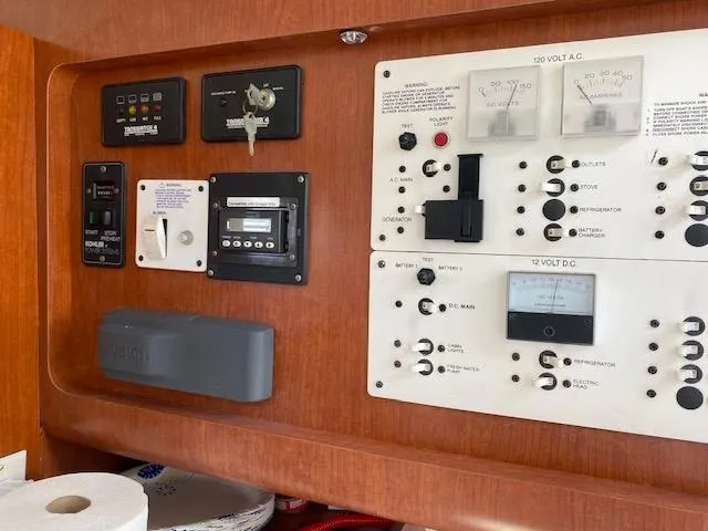 Slide: The Image of Control panel of a 2005 Pro-Line Express boat with various switches and gauges. - 19