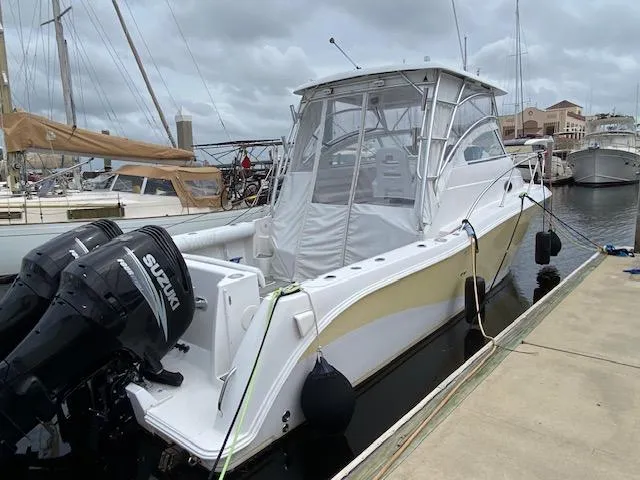 Slide: The Image of 2005 Pro-Line Express boat docked with twin Suzuki outboard motors. - 2