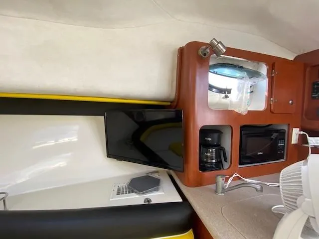 Slide: The Image of 2005 Pro-Line Express interior with TV, coffee maker, and microwave. - 24