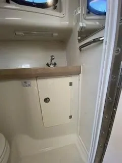 Slide: The Image of 2005 Pro-Line Express boat bathroom with sink and storage cabinet. - 27