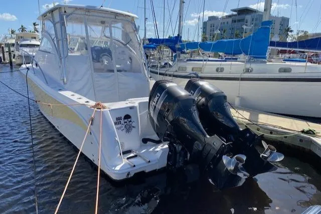 Slide: The Image of 2005 Pro-Line Express boat docked with twin outboard motors. - 4