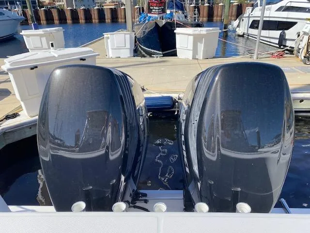 Slide: The Image of 2005 Pro-Line Express boat with dual outboard motors at a marina. - 5