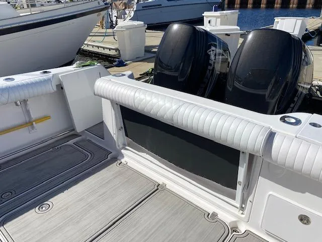 Slide: The Image of 2005 Pro-Line Express boat with dual outboard motors at a marina. - 9