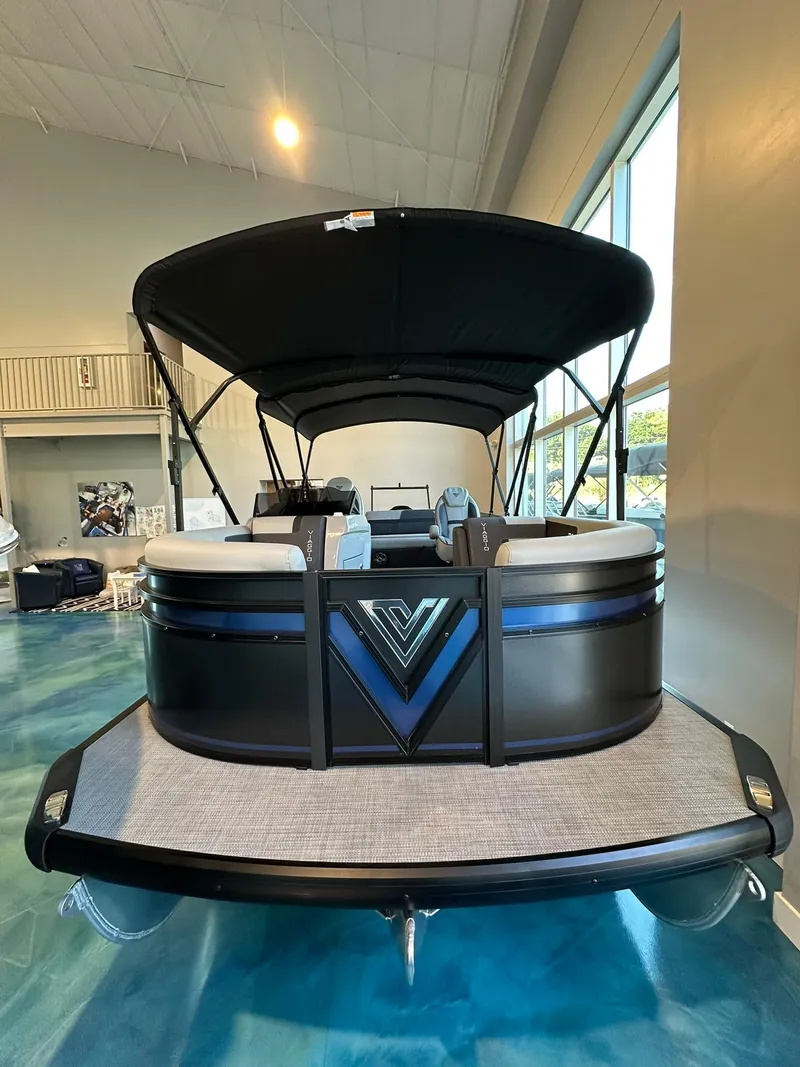 Slide: The Image of 2025 Viaggio Lago X-S pontoon boat with canopy in showroom. - 2