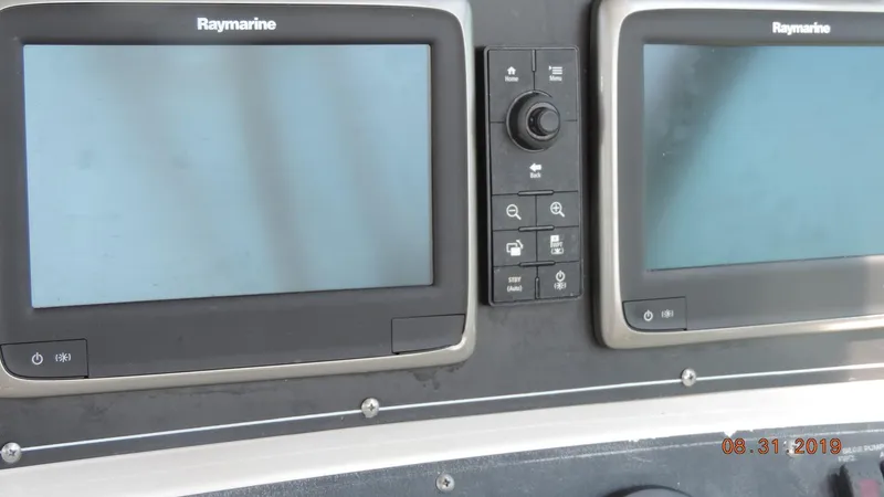 Slide: The Image of Raymarine navigation screens on 2002 Boston Whaler 295 Conquest WA boat dashboard. - 13