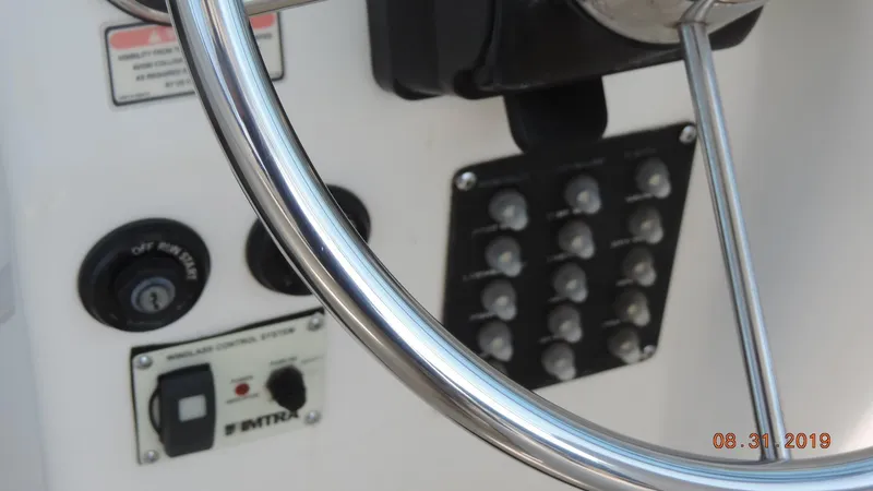 Slide: The Image of Close-up of 2002 Boston Whaler 295 Conquest WA steering wheel and control panel. - 14