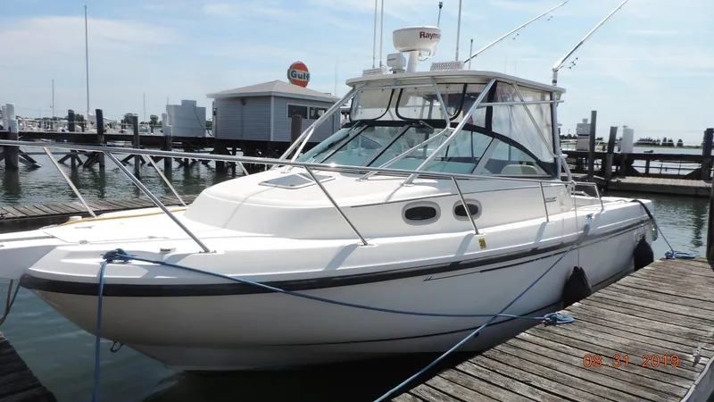 The Image of 2002 Boston Whaler 295 Conquest WA docked at marina. - 2