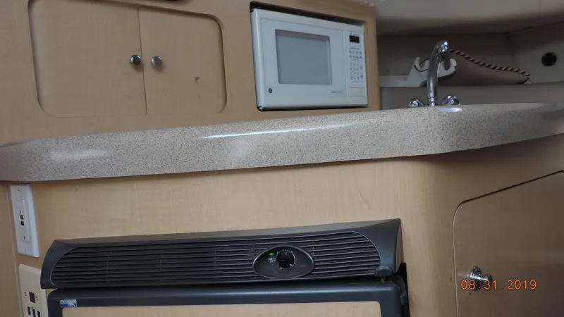 Slide: The Image of Interior of 2002 Boston Whaler 295 Conquest WA with microwave and sink. - 20